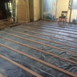 Timber Floor Installation over Concrete floor. Plastic membrane and hardwood battens installed over concrete.