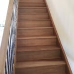 sanding a polishing wooden stairs