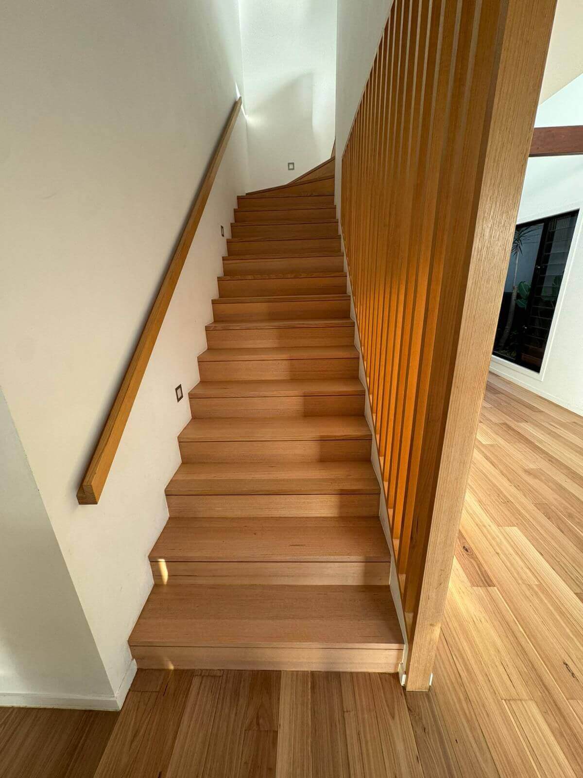image of freshly sanded wooden stairs with wood guard and railing