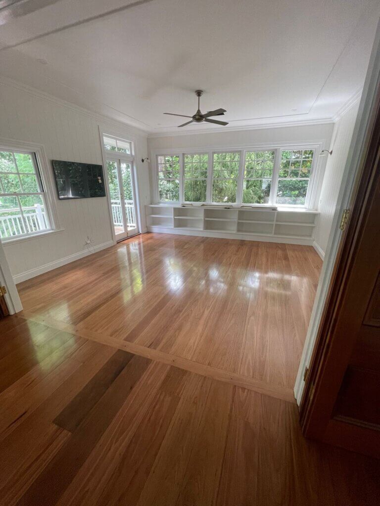 Large open-plan room with a professionally applied polyurethane coating on a freshly sanded timber floor